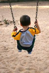 Boy On A Swing At The Park